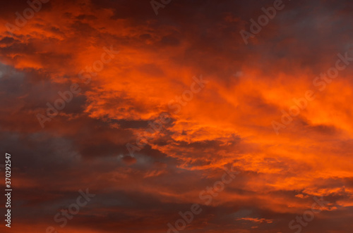 Cloudy landscape at sunset with a beautiful orange sky © Dmitriy Os Ivanov