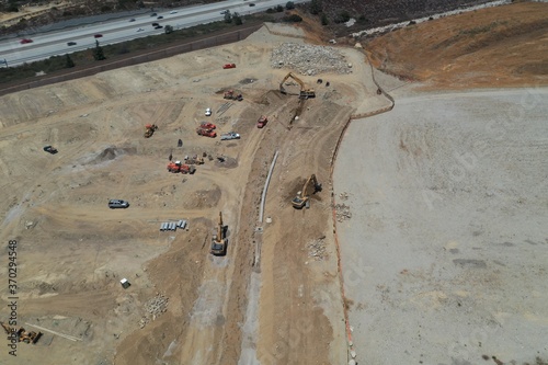Aerial View of Excavator Moving Dirt on Construction Project