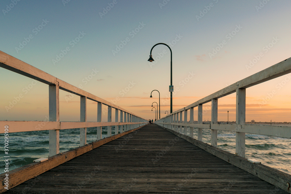 low perspective of symmetrical pier at sunset