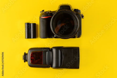 Photographer's equipment.Flat lay composition with photographer's equipment and accessories on yellow background