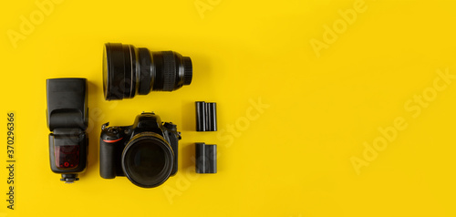 Photographer's equipment.Flat lay composition with photographer's equipment and accessories on yellow background