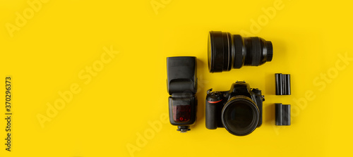 Photographer's equipment.Flat lay composition with photographer's equipment and accessories on yellow background