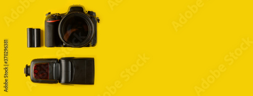 Photographer's equipment.Flat lay composition with photographer's equipment and accessories on yellow background