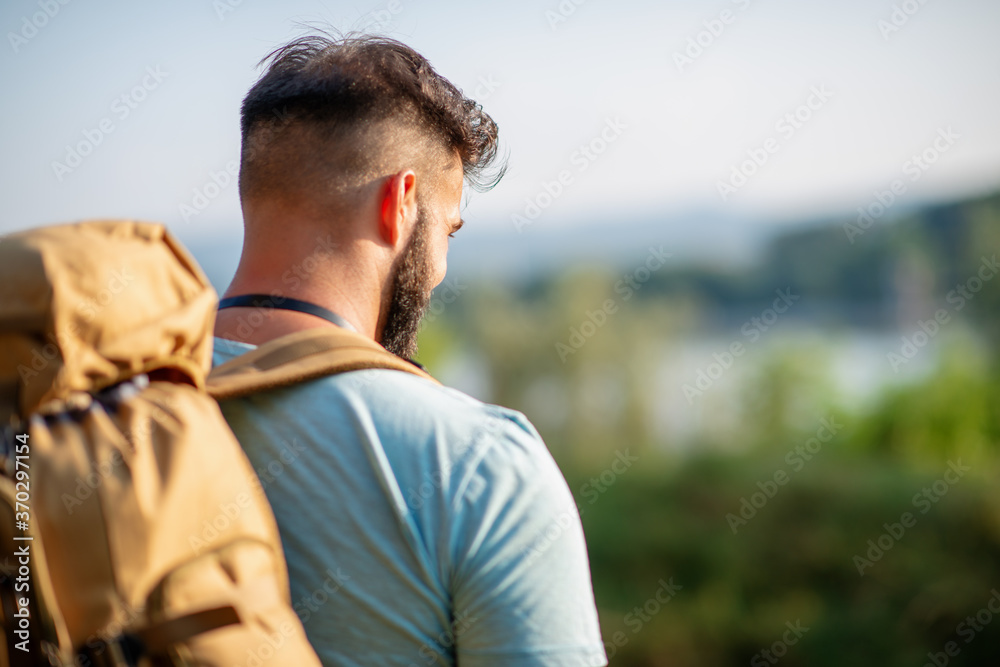 Young man hiking through mountain Young man hiking through mountain