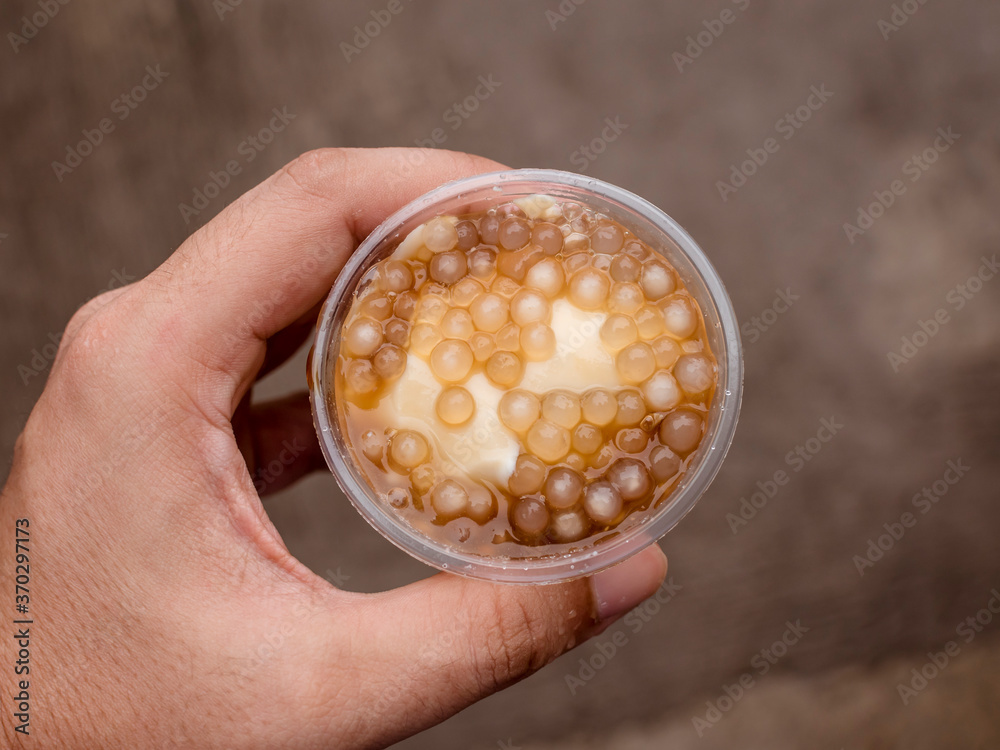 Top view holding Taho, filled with sago pearls. Taho is a Philippine