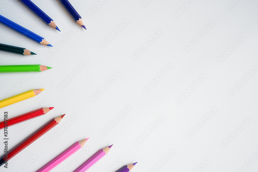 Fototapeta premium The cropped shot view of color pencils with white background, blank copy space screen for your text message or information content.