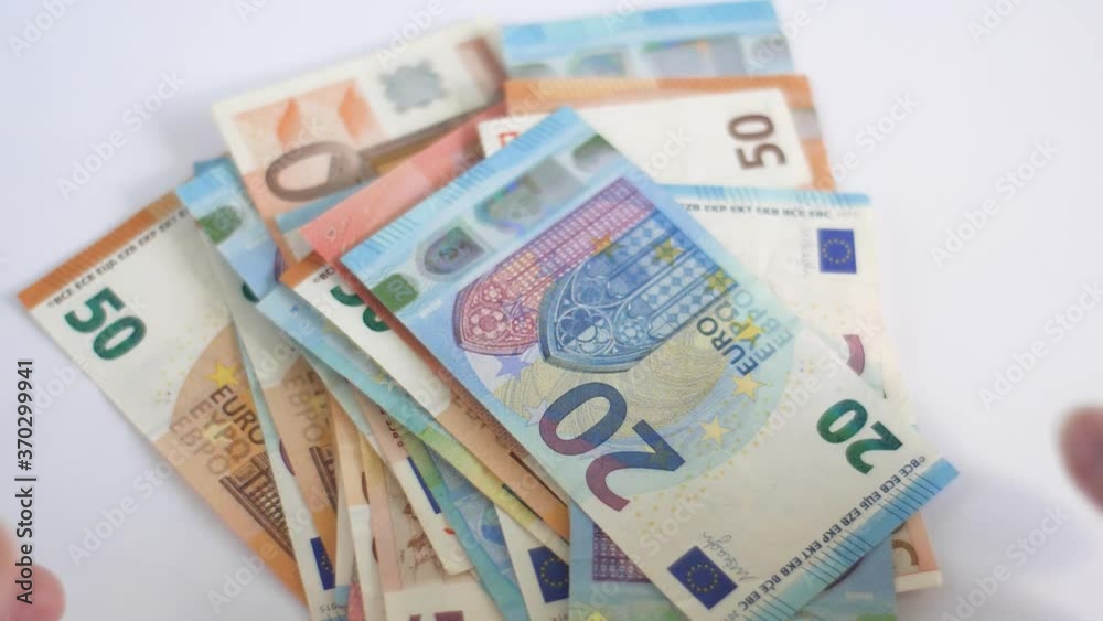 White caucasian womans hands collecting euro money from table White caucasian womans hands collecting euro money from table