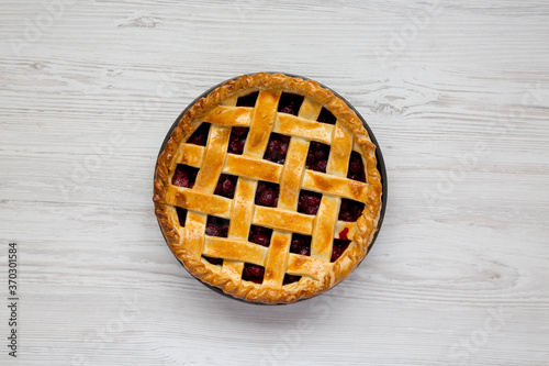 Yummy Homemade Cherry Pie on a white wooden background, top view. Flat lay, overhead, from above.