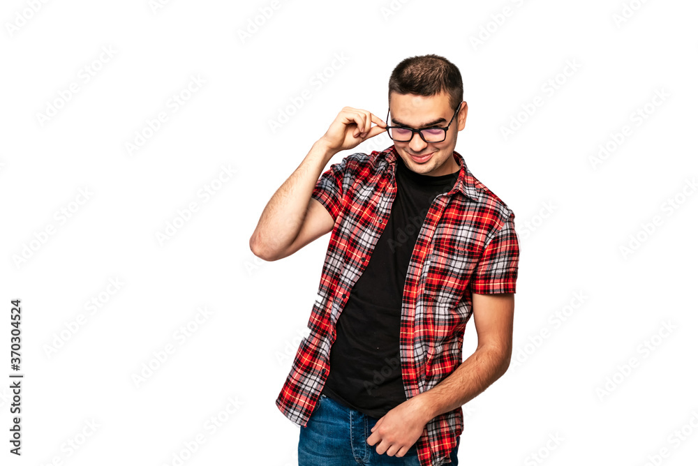 Young man adjusting the glasses. Man smiling isolated on a white background. Handsome male with his finger on eyeglasses looking at camera. Young man adjusting the glasses. Man smiling isolated on a white background. Handsome male with his finger on eyeglasses looking at camera.