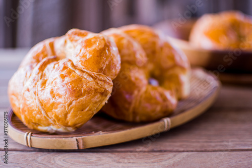 Freshly croissant on wooden background. It is a type of French pastry suitable as breakfast. It can be purchased at bakery worldwide.