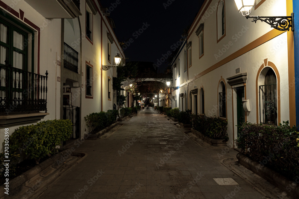 streets of la benezia de canarias in mogan gran canaria at night with beautiful night lights flowers and beautiful architecture of houses