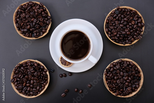 coffee cup and coffee beans on old wood table background
