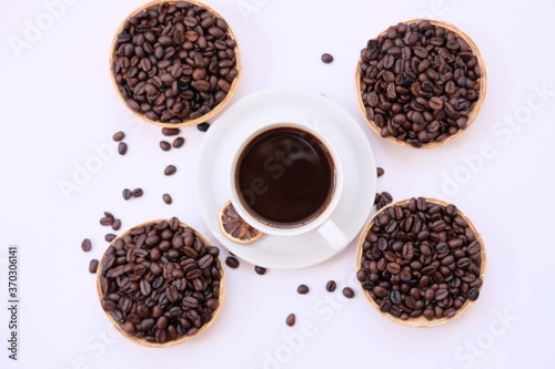 coffee cup and coffee beans on old wood table background