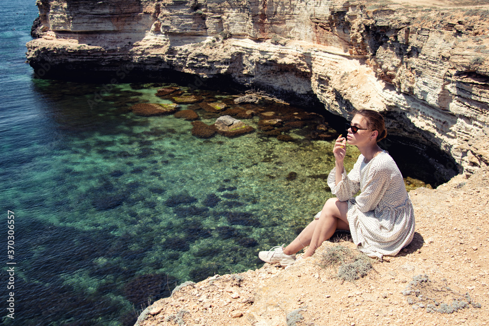 Young attractive girl is resting at the sea. Young attractive girl is resting at the sea.