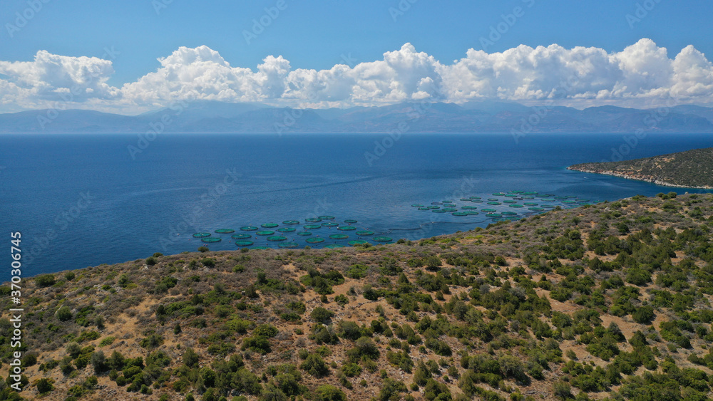 Aerial drone photo of large fish farming unit of sea bass and sea bream in growing cages in calm deep waters of Galaxidi area, Greece Aerial drone photo of large fish farming unit of sea bass and sea bream in growing cages in calm deep waters of Galaxidi area, Greece