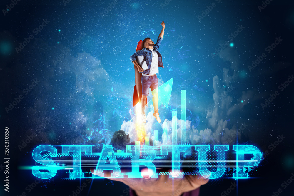 Φωτογραφία The inscription Startup, Businessman taking off on a Rocket on the background of the image of the charts development strategy, business concept, new technologies, hologram