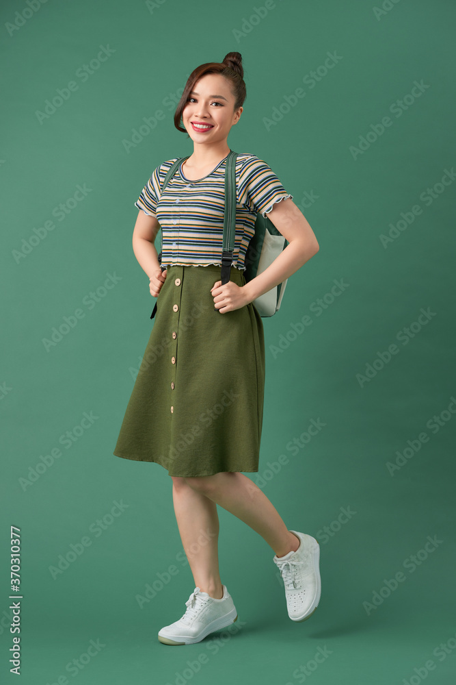 Indoor picture of young good-looking teenage girl isolated on green background, Indoor picture of young good-looking teenage girl isolated on green background,