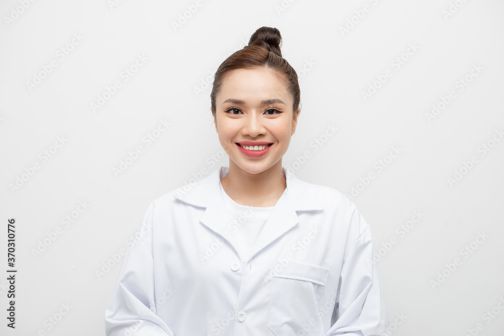 Young smiling female doctor standing isolated on white Young smiling female doctor standing isolated on white