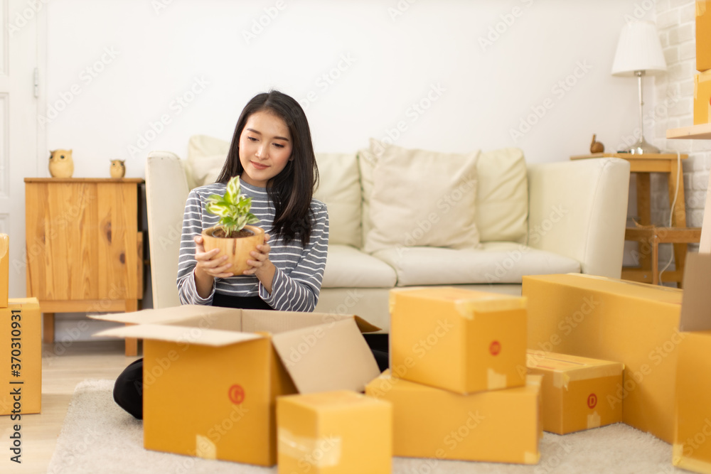 Worker In house Checking Boxes Using Digital Tablet.Start up small business entrepreneur SME or freelance woman working at home concept, Young Asian small business owner,online marketing. Worker In house Checking Boxes Using Digital Tablet.Start up small business entrepreneur SME or freelance woman working at home concept, Young Asian small business owner,online marketing.