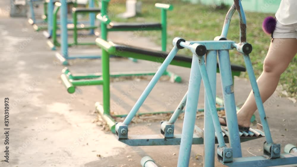 Asian woman doing exercise by using body rider trainer or cycle machine at public park in Thailand
Asian woman doing exercise by using body rider trainer or cycle machine at public park in Thailand