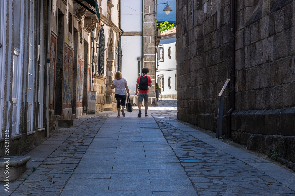 Two People Walking Down European Alley, Portugal