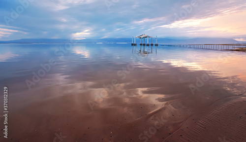 Billede på lærred Calm dead sea surface in the morning, pink and blue sky above, wide angle photo,