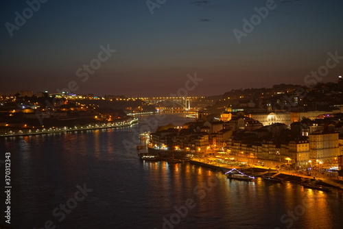 View to Porto over river Douro with reflection of the lights at night