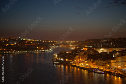 View to Porto over river Douro with reflection of the lights at night