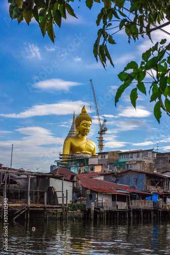 Close-up natural background of the waterfront community  a large Buddha statue  Wat Paknam Phasi Charoen  stands beautifully  seen in tourist attractions in Bangkok  Thailand.