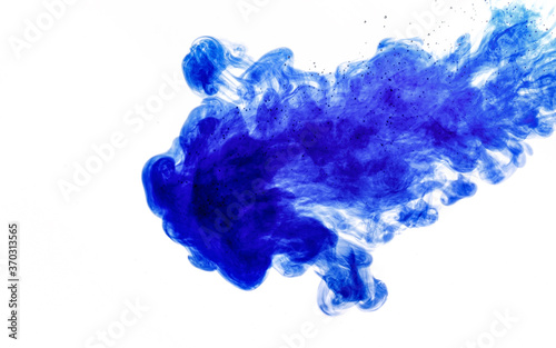 Blue ink injected into water from syringe, colour mixing with water creating abstract shapes