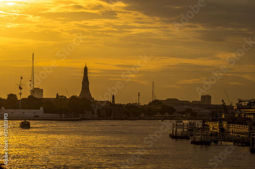 The blurred abstract background of the evening sun shining on the river is naturally golden yellow, the beauty of the clouds and the weather conditions of the day.