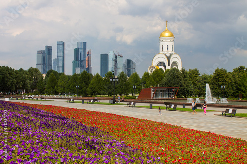 the Church of St. George on Poklonnaya hill in Victory Park and a view of the modern buildings of Moscow city Russia