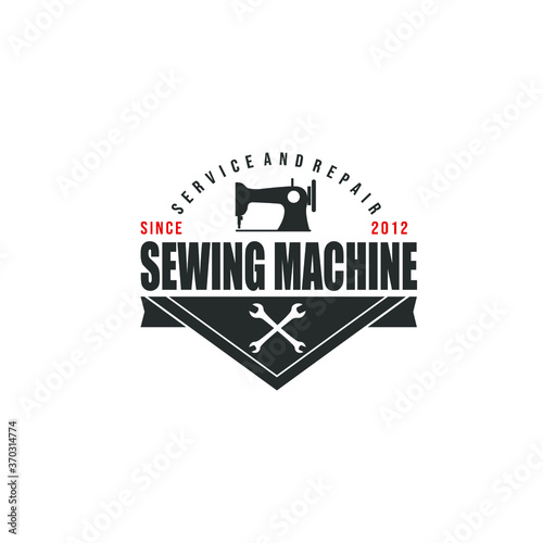 Black sewing machine silhouette and wrench with banner or ribbon isolated on dark background suit for service and repair business logo