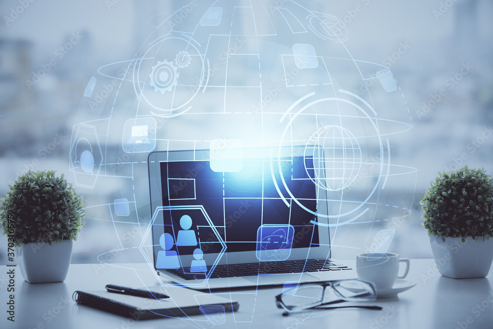 Computer on desktop with social network hologram. Double exposure. Concept of international people connections. Computer on desktop with social network hologram. Double exposure. Concept of international people connections.