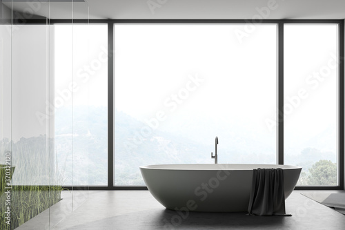 Panoramic concrete floor bathroom with tub © ImageFlow