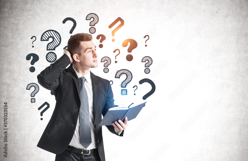 Man with notebook and question marks Man with notebook and question marks