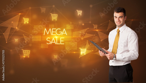 Businessman with shopping cart icons and MEGA SALE inscription, online shopping concept
