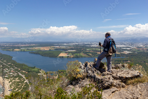 hiker on mountain peak with sea below in circeo national park