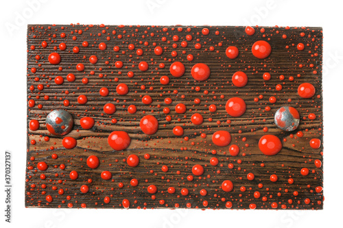 Wooden board with iron bolts in drops of red paint. Isolated