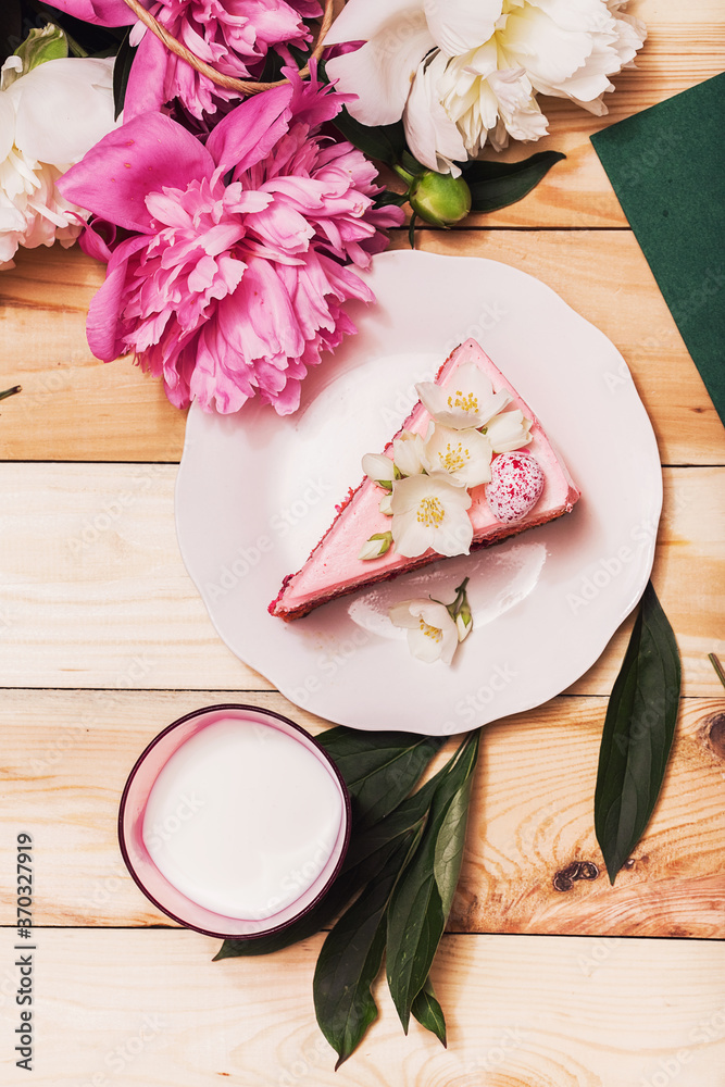 Pink triangle slice of cake with beautiful peonies Pink triangle slice of cake with beautiful peonies