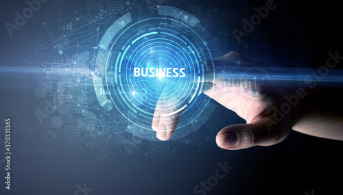Hand touching BUSINESS button, modern business technology concept