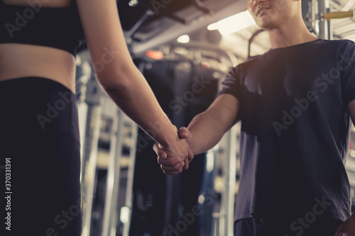Close up handshake of sporty greeting partner exercise workout at fitness gym