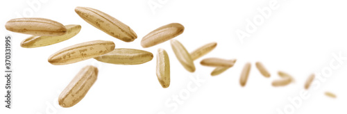 Fototapet Raw rice levitates on a white background