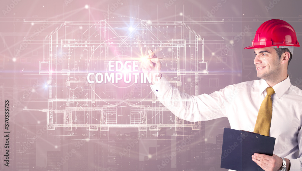 Handsome architect with helmet drawing EDGE COMPUTING inscription, new technology concept Handsome architect with helmet drawing EDGE COMPUTING inscription, new technology concept