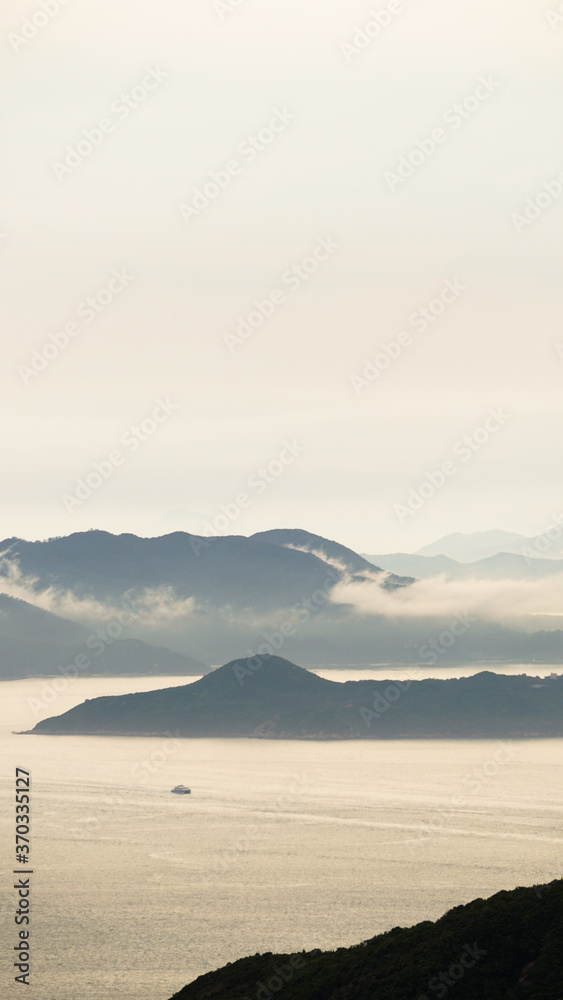 Obraz premium Hong Kong ocean sunset mountain heaven background nautical vessel cargo ship industry