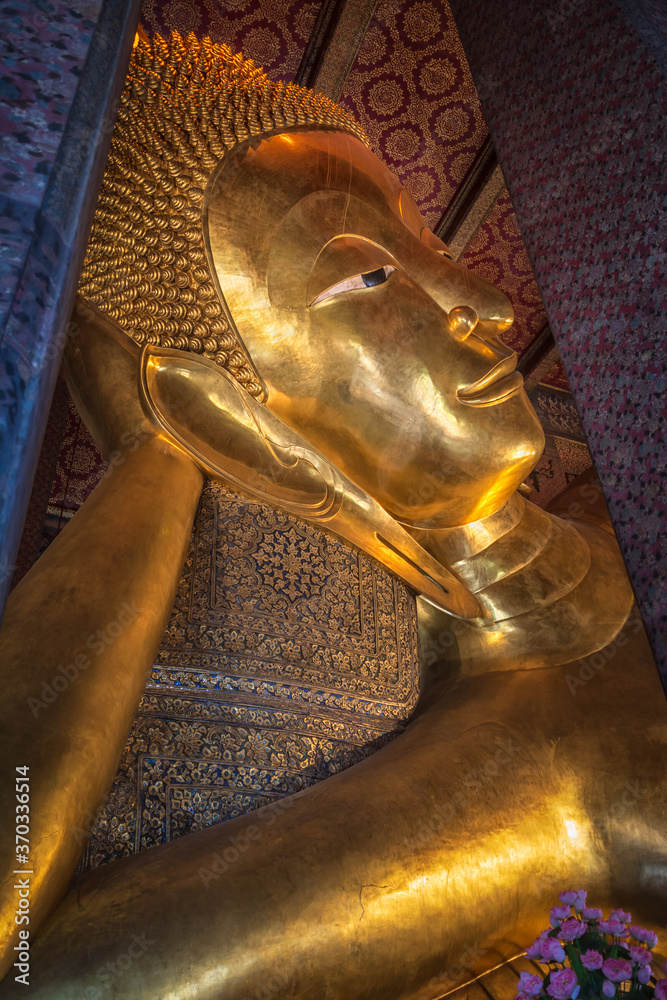 Bangkok, Thailand - August 14, 2020: Giant reclining Buddha on the famous Buddhist temple Wat Pho. Bangkok, Thailand.