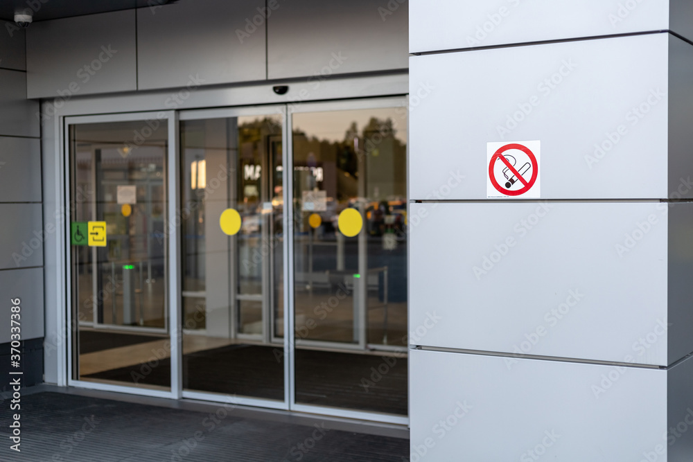 No smoking sign at the entrance with large glass doors