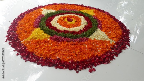 Beautiful colourful flower rangoli on white tiles in the varandha during harvest festival onam in kerala  south india