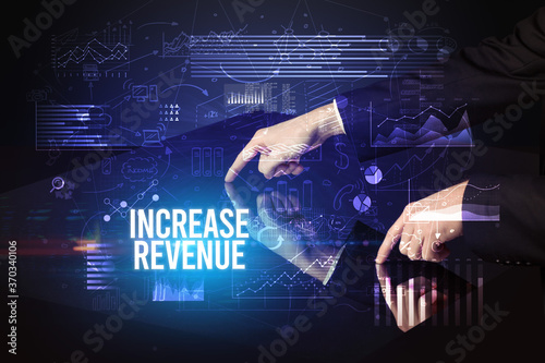 Businessman touching huge screen with INCREASE REVENUE inscription, cyber business concept