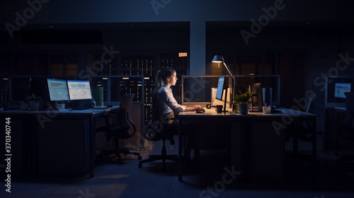 Tableau sur toile Working Late at Night in the Office: Businesswoman Uses Desktop Computer, Analyzing, Using Documents, Solving Problems, Finishing Important Project